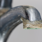 Hard water mineral buildup on household fixtures
